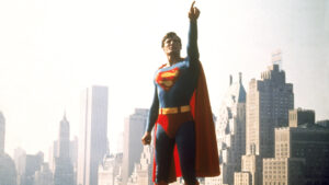 A still of Christopher Reeve as Superman pointing to the sky.